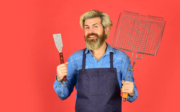 istock fried on grill. mature chef use cooking utensils for barbecue. Tools for roasting meat. Who cook better. Ultimate cooking challenge. prepare dinner for family. cooking utensils and various products 1460593099
