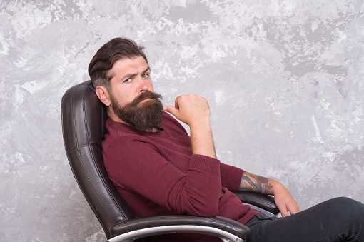 Professional and skilled. Serious businessman. Businessman relax in office chair. Bearded businessman wear business casual. Brutal look of businessman with hipster beard and mustache. Barber shop.