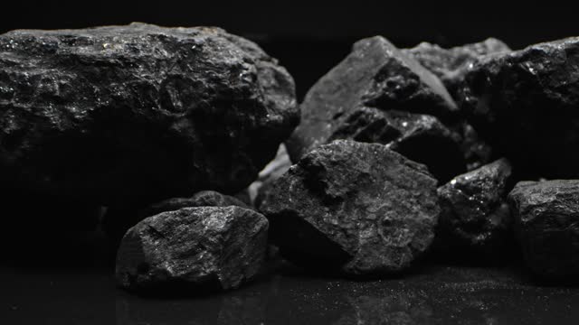 Close-up of lumps of coal. Left camera movement.