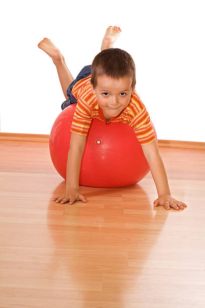 istock Little boy playing on large red gymnastic ball 146059526