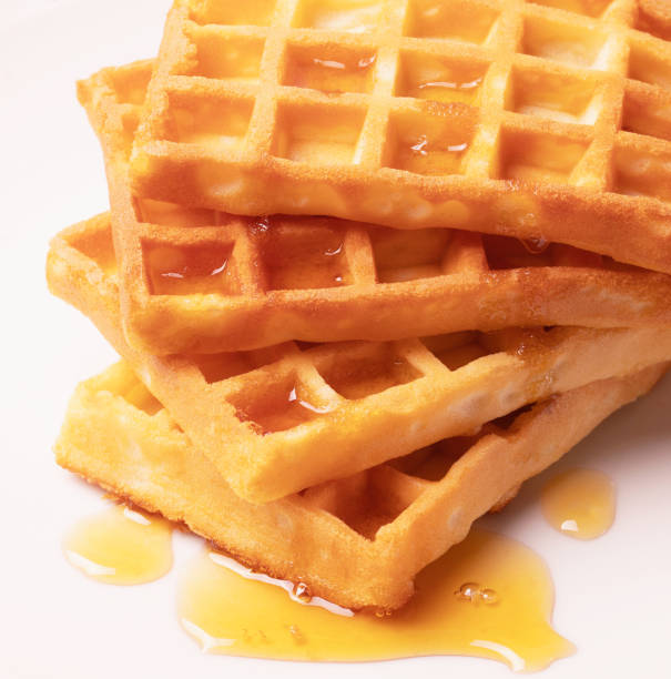 istock Delicious Belgian waffles with honey served on white plate 1460599834