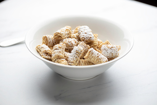 Shredded wheat cereal in a white bowl