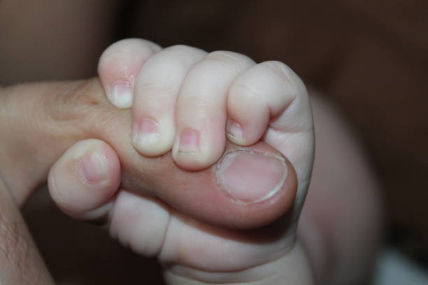 istock little newborn baby hand squeezing daddy's finger 1460600119