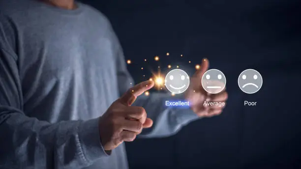 Photo of Customer satisfaction and service quality survey, Businessman pointing a smiley face icon to assess satisfaction with product and services on a virtual screen, highest level, positive feedback.