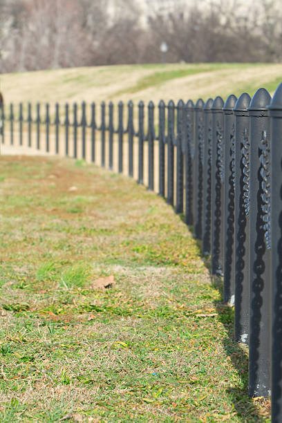 istock Row of Fences Posts Curving Away from the Camera 146060764