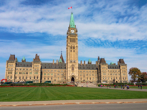 Ottawa, Canada - September, 2019: Frontal view of the 'Centre Block' section of the Canadian Parliament. It houses the House of Commons, Senate chambers, offices of members of parliament, senators, and senior administration for both legislative house.