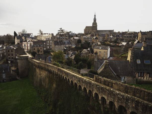 Panorama of ancient historic stone house buildings city wall bridge in village town Dinan in Brittany France Europe stock photo
