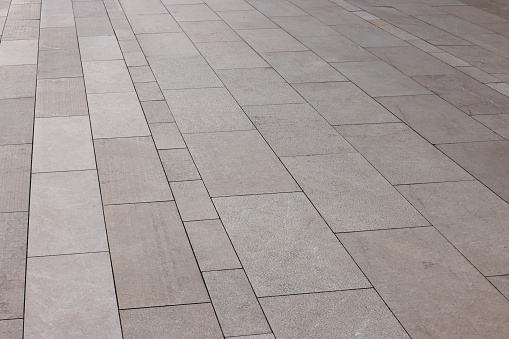 New home yard paving bordered by a gravel area with rocks.