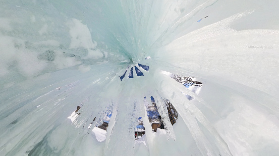 A ultra wide angle view looking directly up through a frozen waterfall.