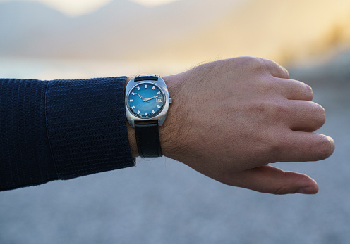 Vintage wrist watch on man's arm, close up