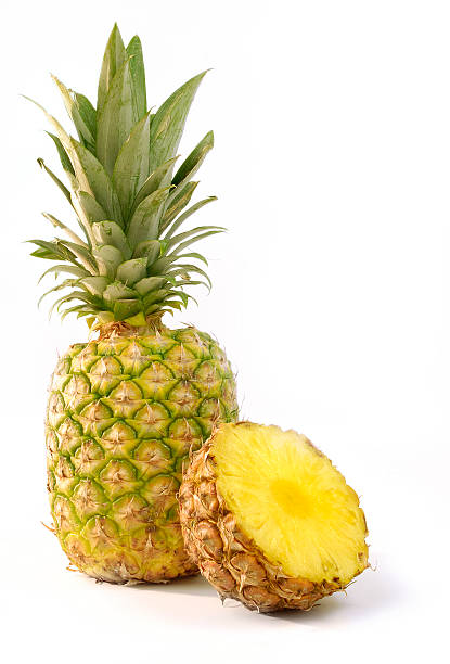 Whole and halved pineapple isolated on white background