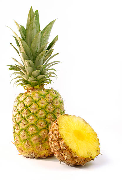 Whole and halved pineapple isolated on white background stock photo