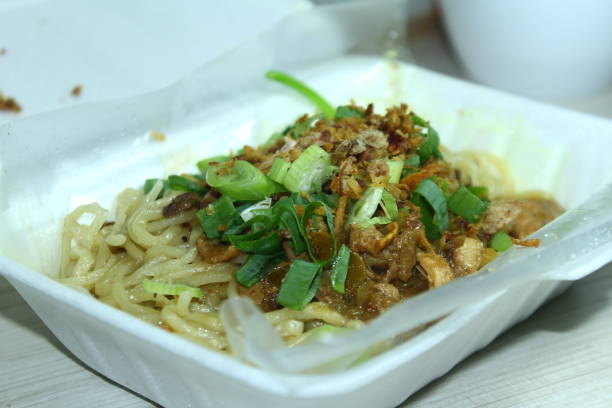 Mie ayam, typical Indonesian food,noodles with chicken and vegetables in a styrofoam box Asian food delivery, street food concept