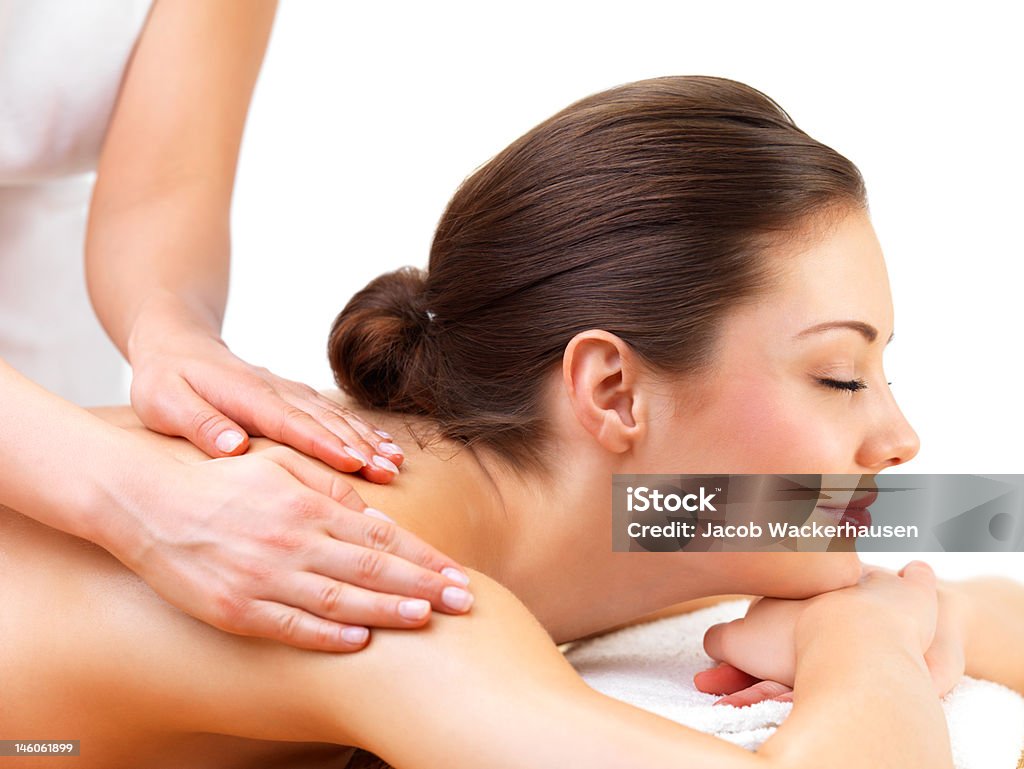 Young woman at a day spa Close-up of young woman receiving back massage at day spa Adult Stock Photo