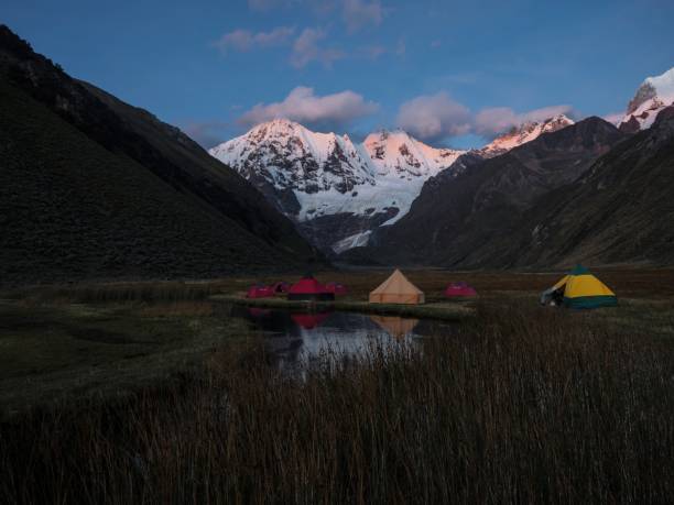 Sunrise panorama of andes mountain Jirishanca tent Camp Jahuacocha lake Cordillera Huayhuash Circuit Ancash Peru stock photo