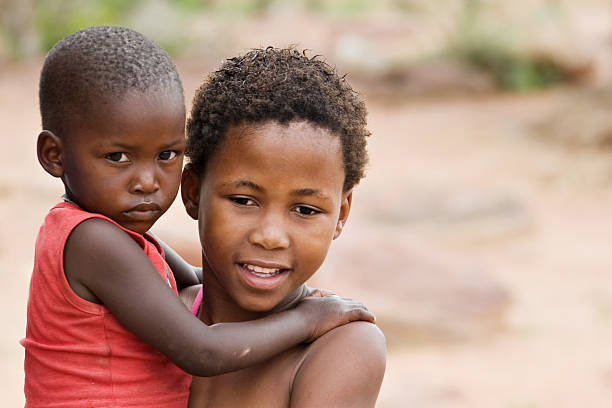 istock African boy carrying his brother 146062256