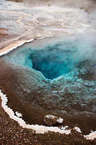 Turquoise bright blue boiling hot volcanic geothermal natural pond pool lake at Geysir Haukadalur Golden Circle in Iceland