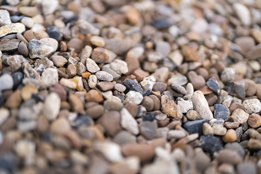Boulder pebble beach stones background seamless texture for design use. Naturally rounded gravel at river. Nature background texture pattern