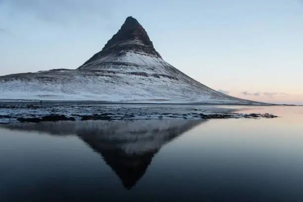 Photo of Winter panorama mirror reflection of Kirkjufell mountain blue hour sunrise Grundarfjordur Snaefellsnes Peninsula Iceland