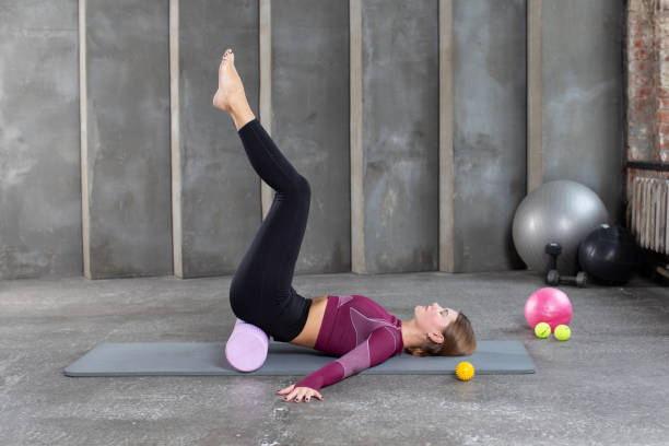 istock A woman performs myofascial unloading of the buttocks, using rolling on a yoga mat. Myofascial release, MFR. 1460629072