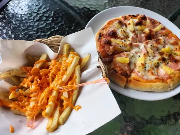 Love to eat frenchfries and pizza.