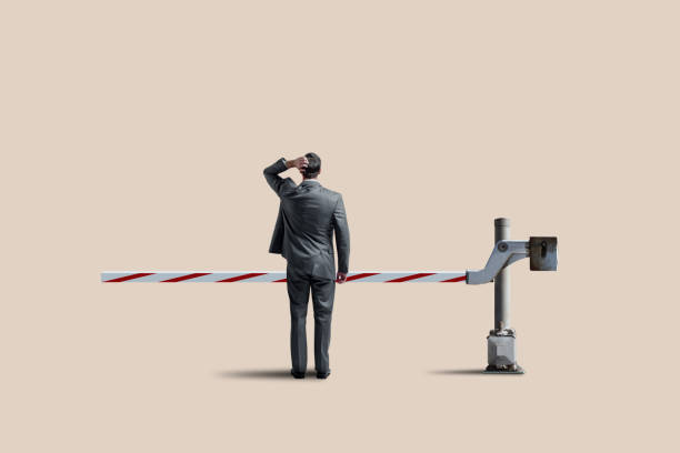 man standing at a roadblock - problems adversity conquering adversity roadblock imagens e fotografias de stock