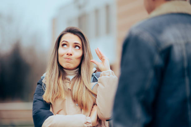 Woman Tired of The Endless Explanations of her Boyfriend Bored annoyed girlfriend feeling distrustful and patronizing rolling eyes stock pictures, royalty-free photos & images
