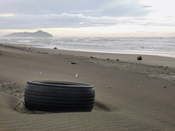 istock Environmental concept. Old car tires on the beach. 1460637779