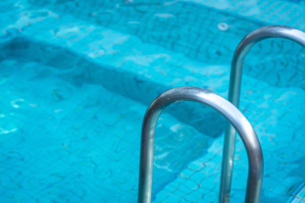 istock Grab bar ladder in swimming pool. 1460641717