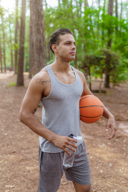 Man walking to basketball court. Health and wellness concept.