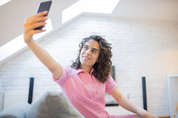 istock Happy young woman using phone 1460644436