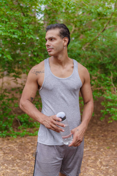 istock Portrait of athlete man holding bottle for hydration 1460644503
