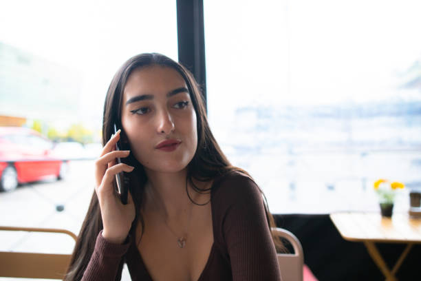 istock Happy young woman speaking on cellphone 1460646876