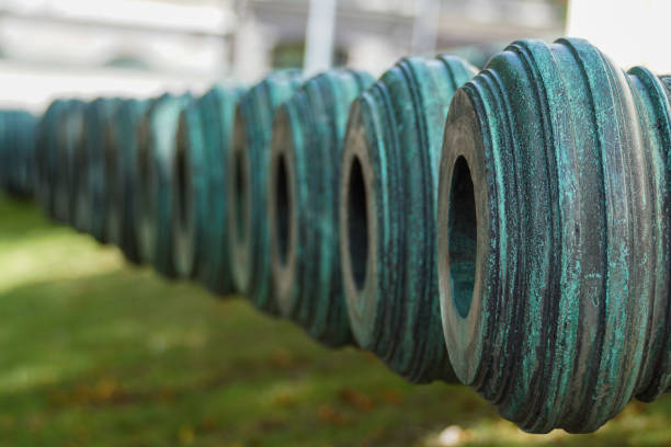 green old cannons in a row outdoors