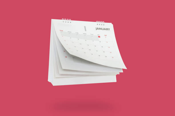 White paper desk calendar flipping page mockup isolated on red background White paper desk calendar flipping page mockup isolated on red background flip calendar stock pictures, royalty-free photos & images