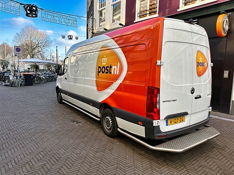 den haag, netherlands - january 23 2022: a delivery truck of delivery organisation post.nl on a city street