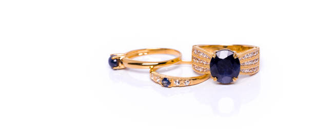 Blue Sapphire with diamonds Jewel or gems ring on white background with reflection. Collection of natural gemstones accessories. Studio shot