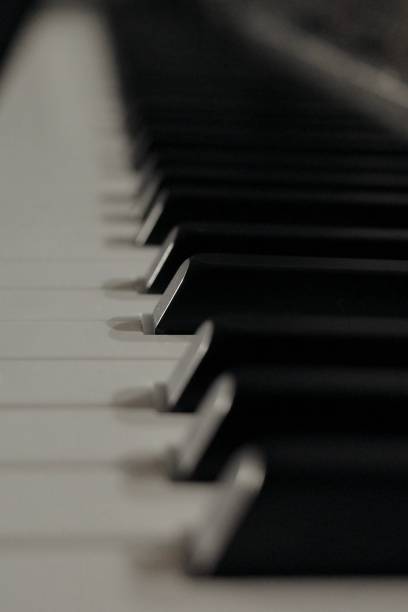 istock piano keyboard instrument close-up in dark room 1460650237