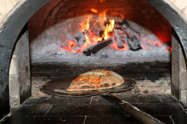 istock Pizza in the wood oven 1460653496