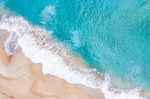 A ocean waves and beach top view, a natural background.