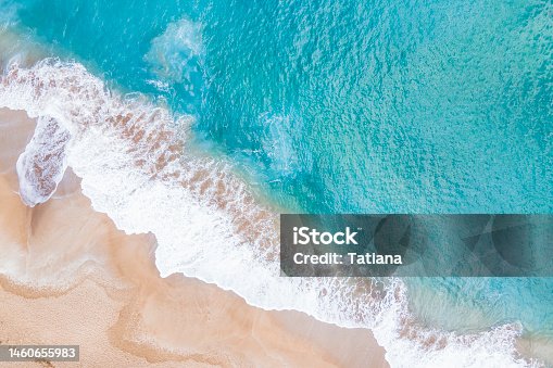 istock A ocean waves and beach top view, natural background. 1460655983