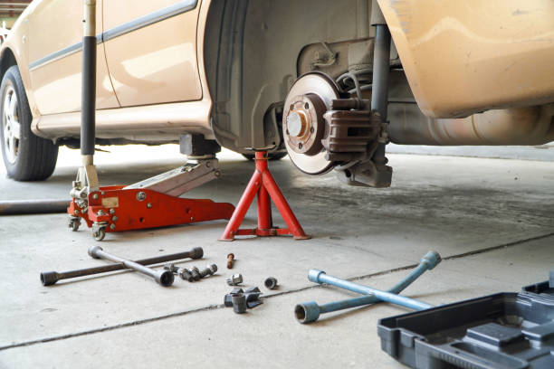 istock Modern Vehicle and the Floor Jack Lift Vehicle Servicing 1460657335