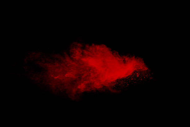 istock Red particle explosion on black background.Freeze motion of red dust splash. 1460661625