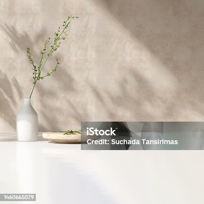 istock Modern white vase with green plant, wooden plate on stone counter table with space in sunlight, leaf shadow on beige stucco cement wall 1460665079