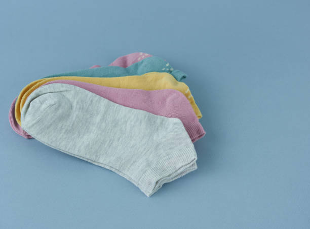 istock Multicolored children's socks on a blue background close-up. 1460665671
