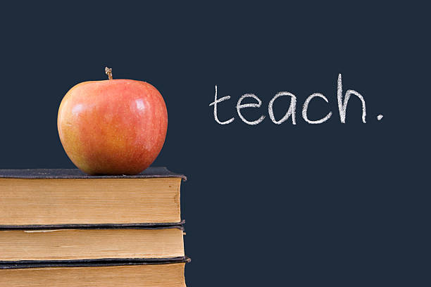 istock teach written on blackboard, apple, books 146066776