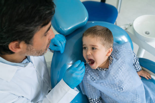 istock Boy opening his mouth at the dentist 1460670795