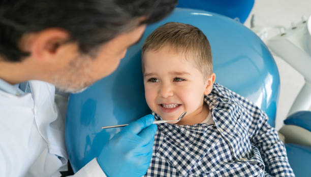 istock Happy boy showing his teeth to the dentist 1460670823