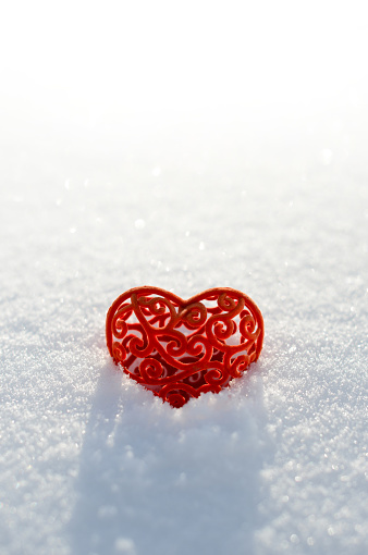 Two Christmas red heart-shaped snowman balloons floating in mid-air on white background.