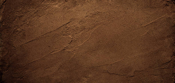 Dark chocolate brown sugar-like grainy texture background stock photo